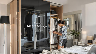  Young couple organizing robes in sleek modern wardrobe with 'Smart Storage' text