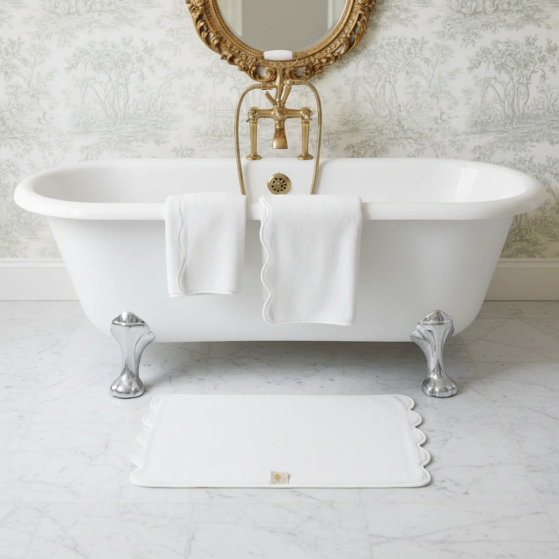 Elegant white scallop-piped cotton hand towels draped over a clawfoot tub for indulgent spa-quality comfort - Lotus Linen