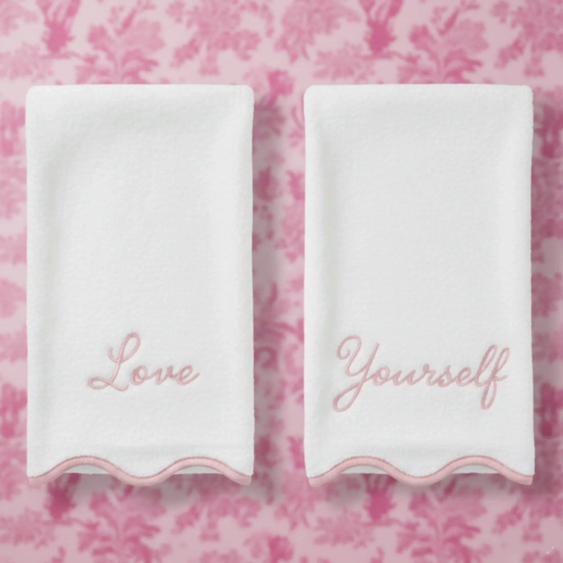 Pair of white cotton hand towels with pink Love Yourself embroidery and scallop piping for everyday self-care - Lotus Linen