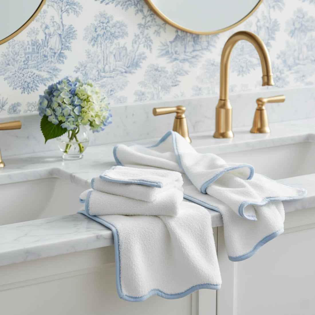 White scallop-edged bath towel set with soft blue piping styled on marble vanity for spa-quality comfort - Lotus Linen