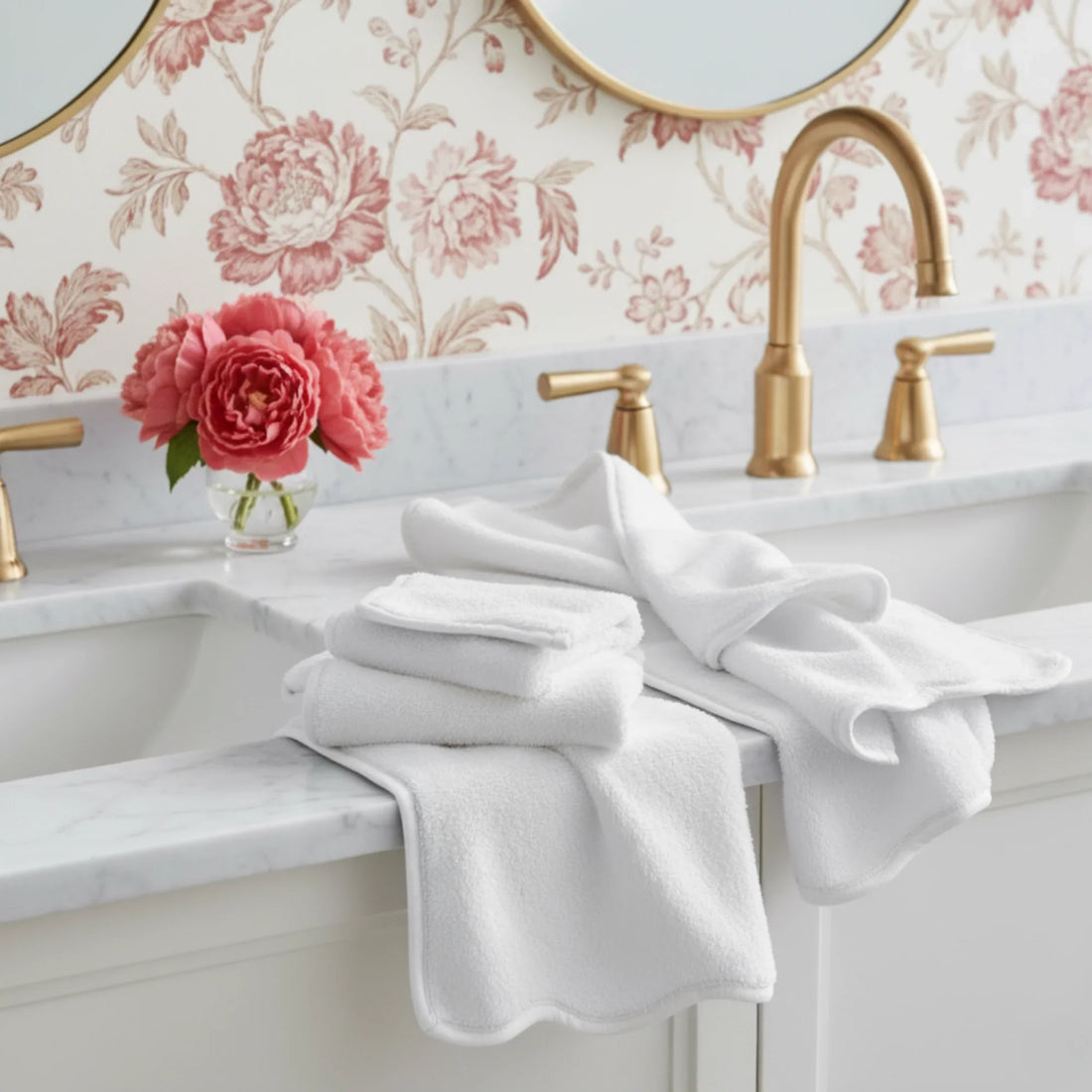 Soft white scallop-piped luxury cotton washcloths styled on marble vanity for everyday spa-quality comfort - Lotus Linen