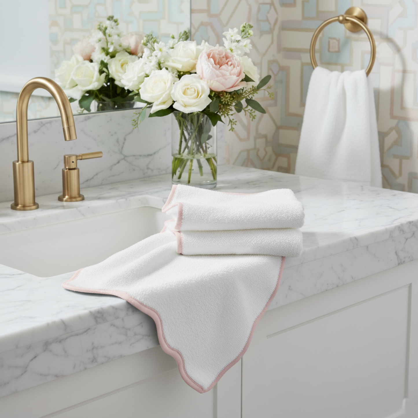 White scallop piping bath towels with blush trim on marble countertop for everyday indulgent spa-quality comfort - Lotus Linen
