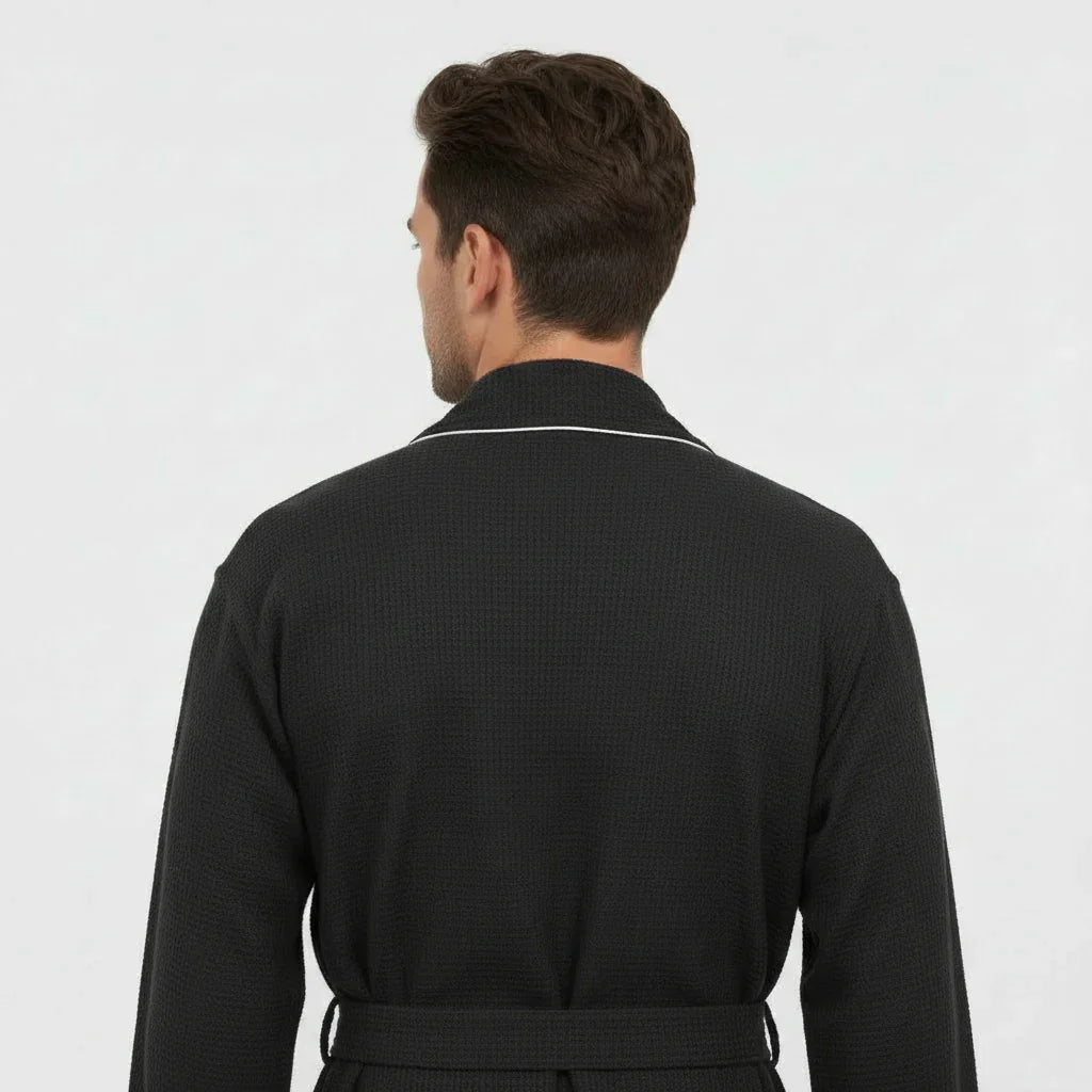 Man wearing black waffle piping robe with white trim, effortless spa-quality comfort at home - Lotus Linen