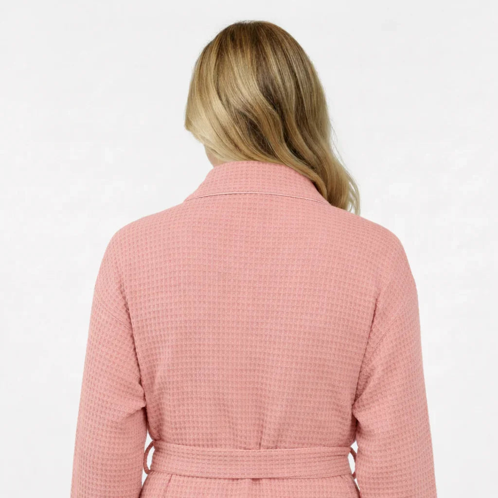 Woman modeling pink waffle-knit knee-length robe with tie belt in spa-quality comfort - Lotus Linen