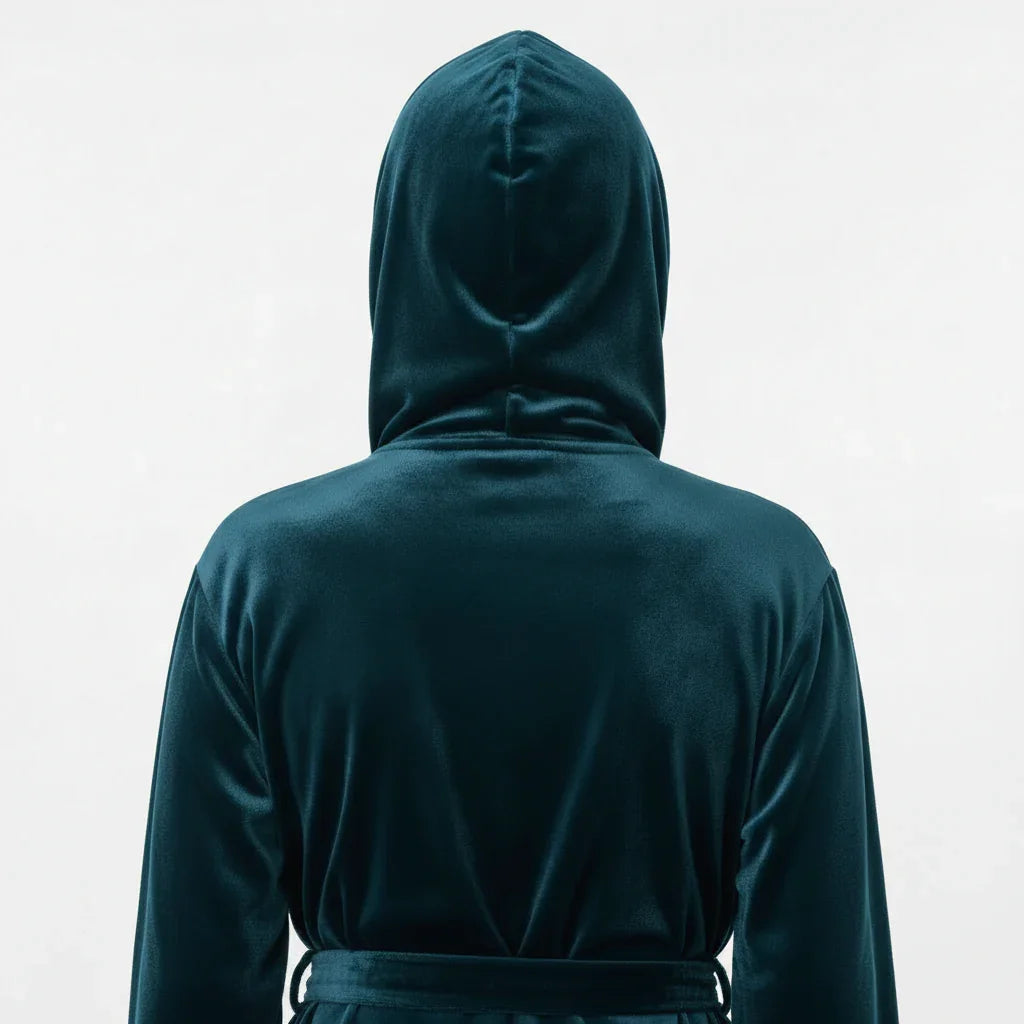 Woman wearing deep teal plush hooded robe viewed from behind, evoking spa-quality comfort at home - Lotus Linen
