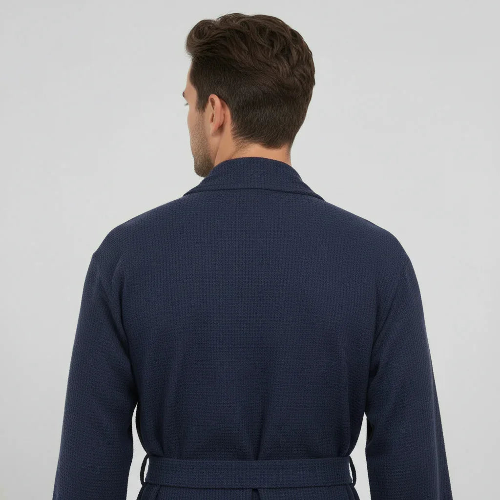 Man wearing navy waffle spa bathrobe with tie belt for lightweight, absorbent comfort after every shower - Lotus Linen