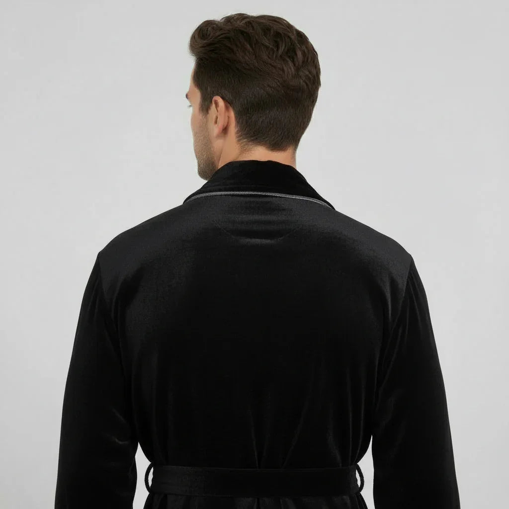 Man in black plush robe with satin trim seen from back, radiating spa-quality comfort and effortless elegance - Lotus Linen
