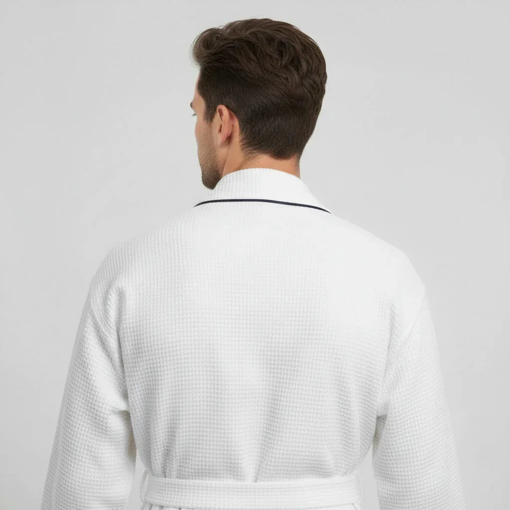 Man wearing white waffle piping robe with navy trim for spa-quality comfort at home - Lotus Linen