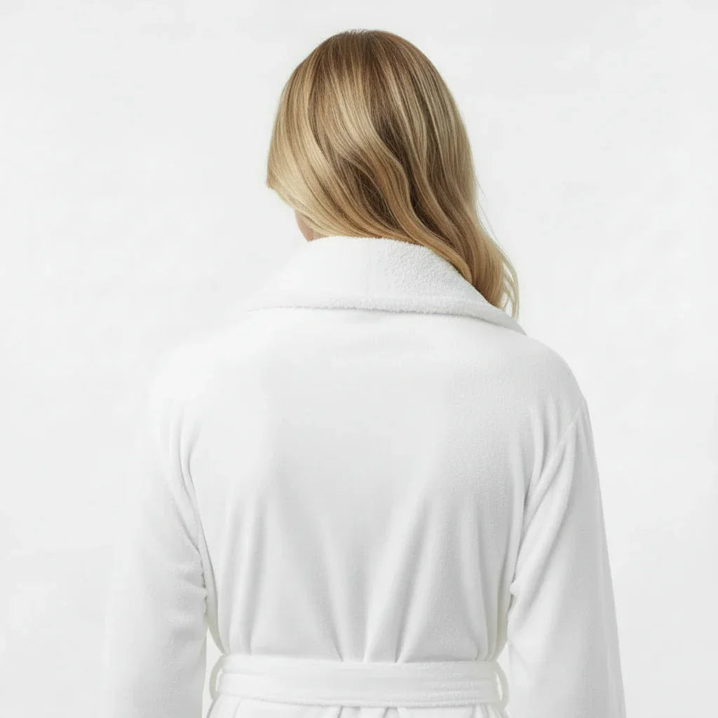 Woman wearing white plush bathrobe with soft shawl collar for spa-quality comfort at home - Lotus Linen
