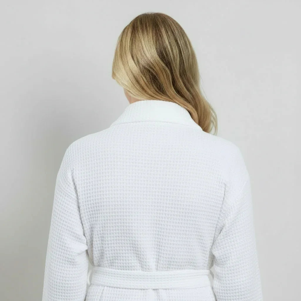 Woman modeling white waffle-weave knee-length robe with cozy spa-quality comfort, back view - Lotus Linen