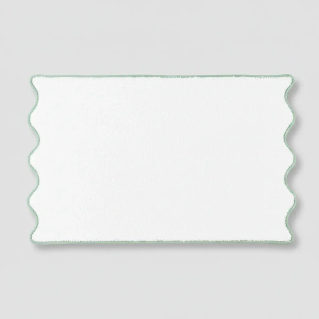 Treat yourself to spa-quality comfort with this fluffy white bath towel featuring a soft green scalloped edge - Lotus Linen