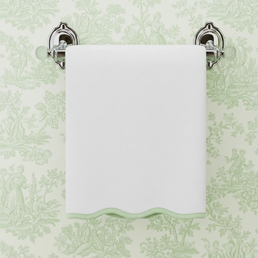 White cotton washcloth with mint green scallop piping hung on chrome towel bar for everyday indulgent softness - Lotus Linen