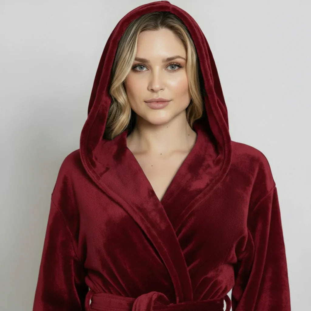Woman wearing a plush hooded robe in deep burgundy for cozy spa-worthy comfort at home - Lotus Linen