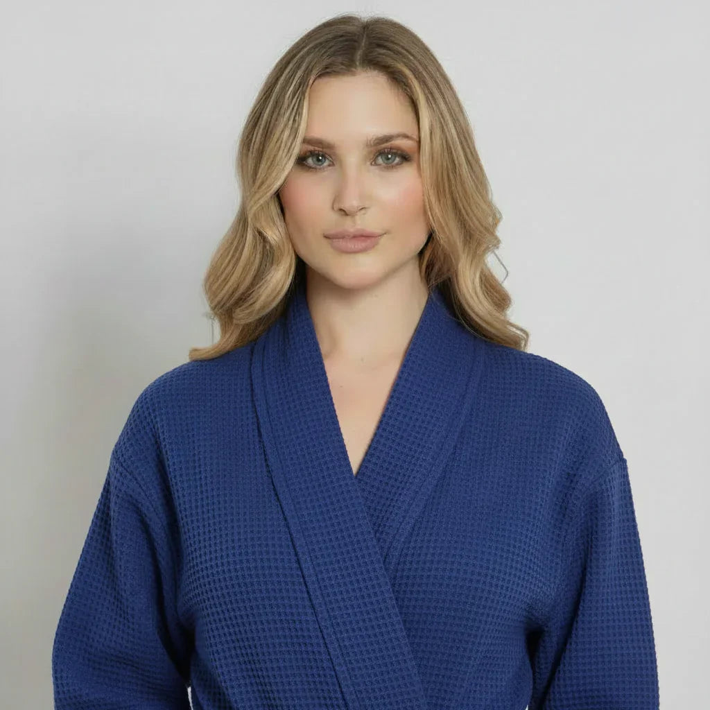 Woman in navy blue waffle-knit knee-length robe offering spa-quality comfort and effortless relaxation - Lotus Linen