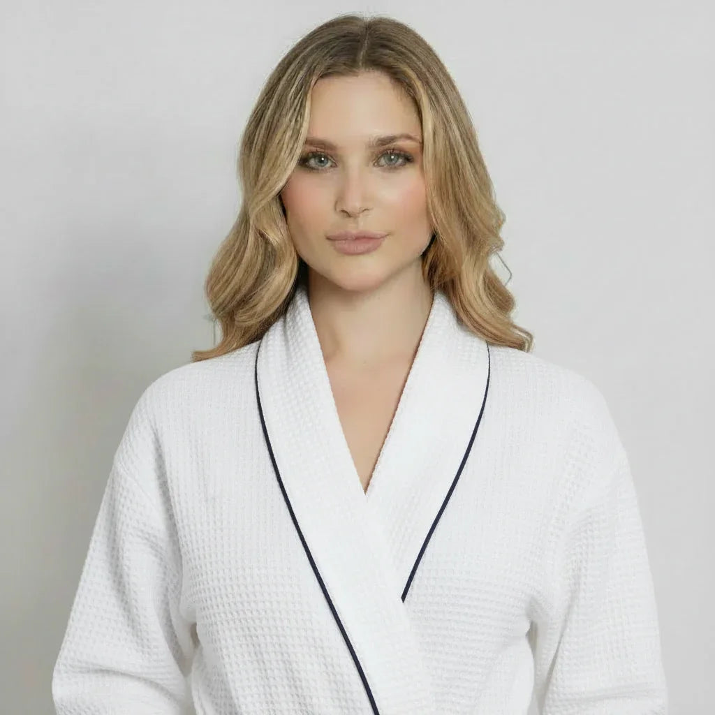 Woman in white waffle knee-length robe with navy piping for effortless spa-quality comfort at home - Lotus Linen