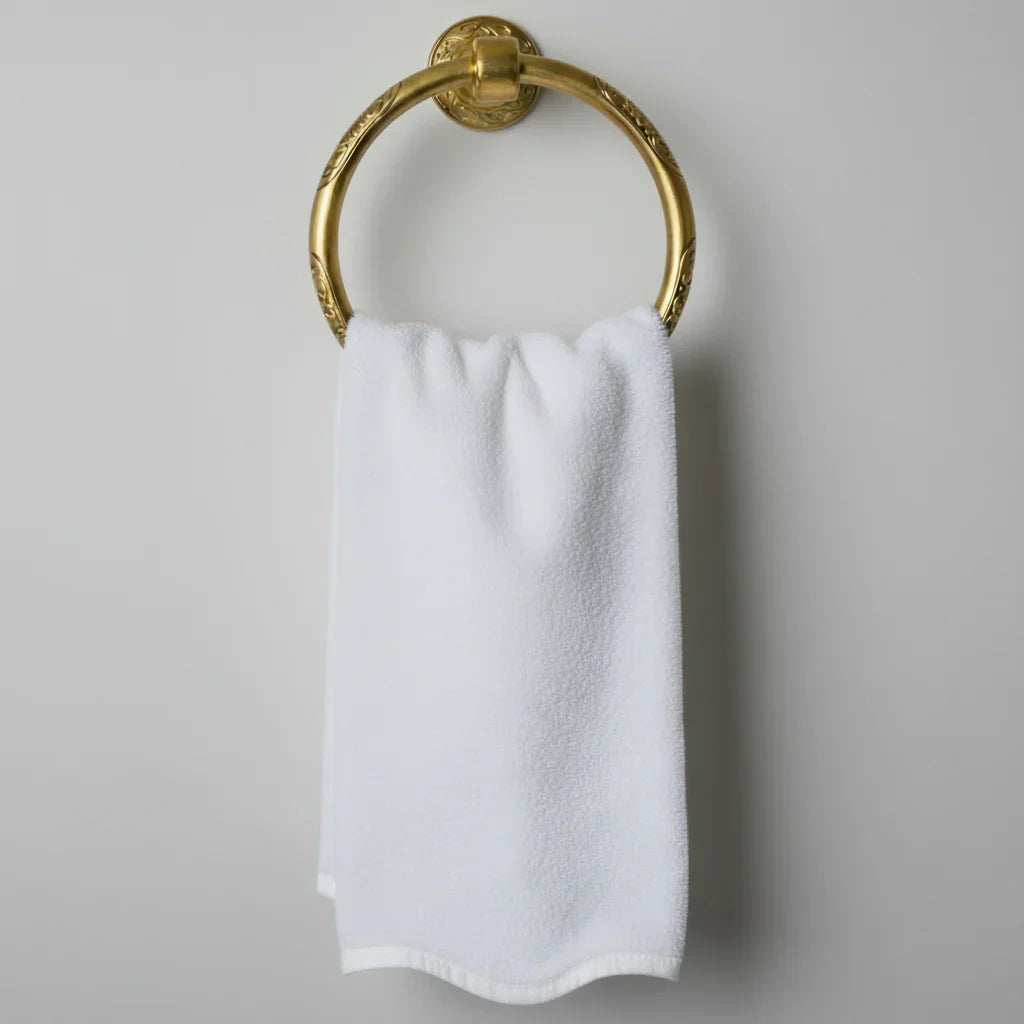 White cotton hand towel on ornate gold towel ring offering spa-quality softness for your daily pampering ritual - Lotus Linen