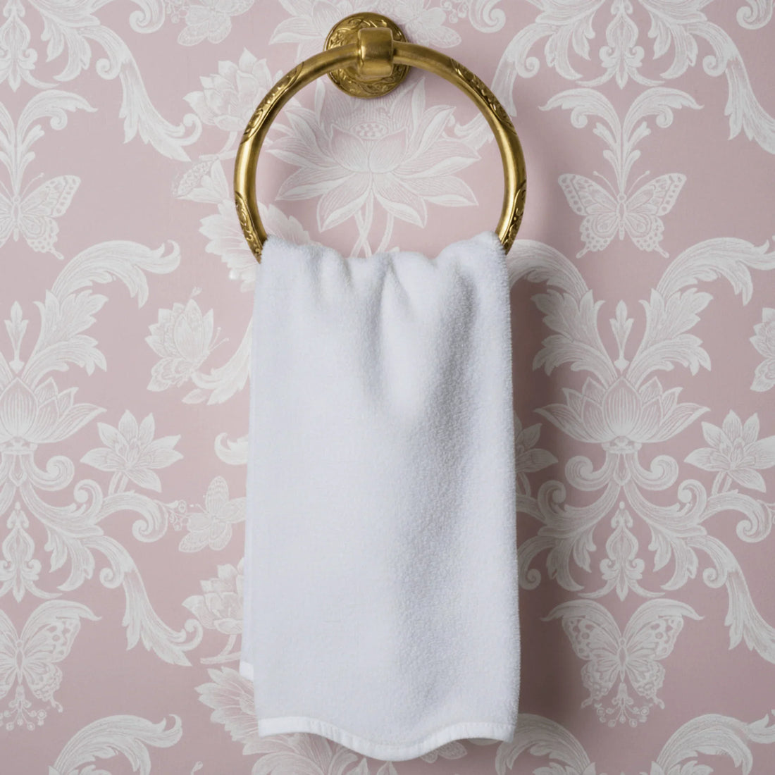 Soft white bath towel draped on gold ring holder offering plush spa-quality comfort for your daily routine - Lotus Linen